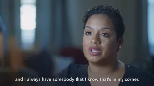 Black woman teacher sitting with subtitle "and I always have somebody that I know that's in my corner.