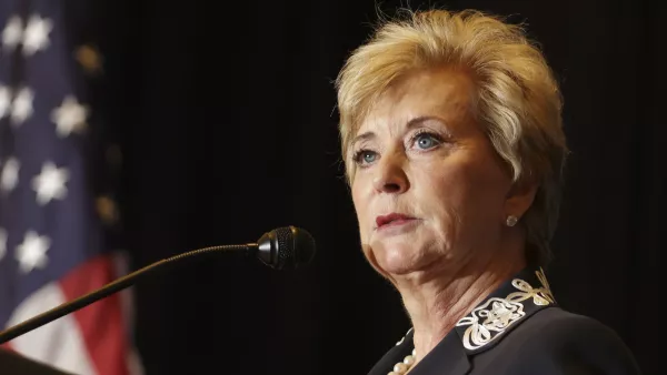 A picture of Secretary of Education Nominee Linda McMahon at a microphone. An American flag can be seen in the background to the left.