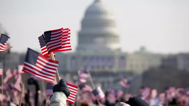 Hands waving flags at the US Capitol