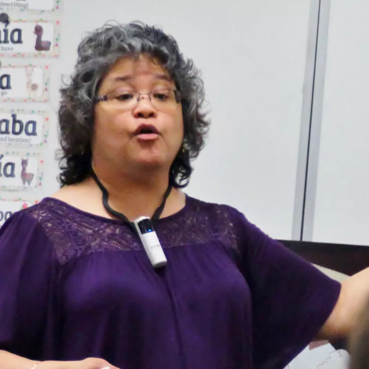 Kerisa Baedke stands in front of her class teaching.